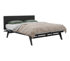 Modern bed with black frame, beige comforter, and green pillows on a white background