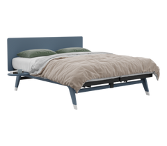 Blue bed frame with beige blanket and green pillows on a white background