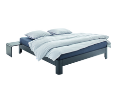 Bed with gray frame and white bedding on a white background