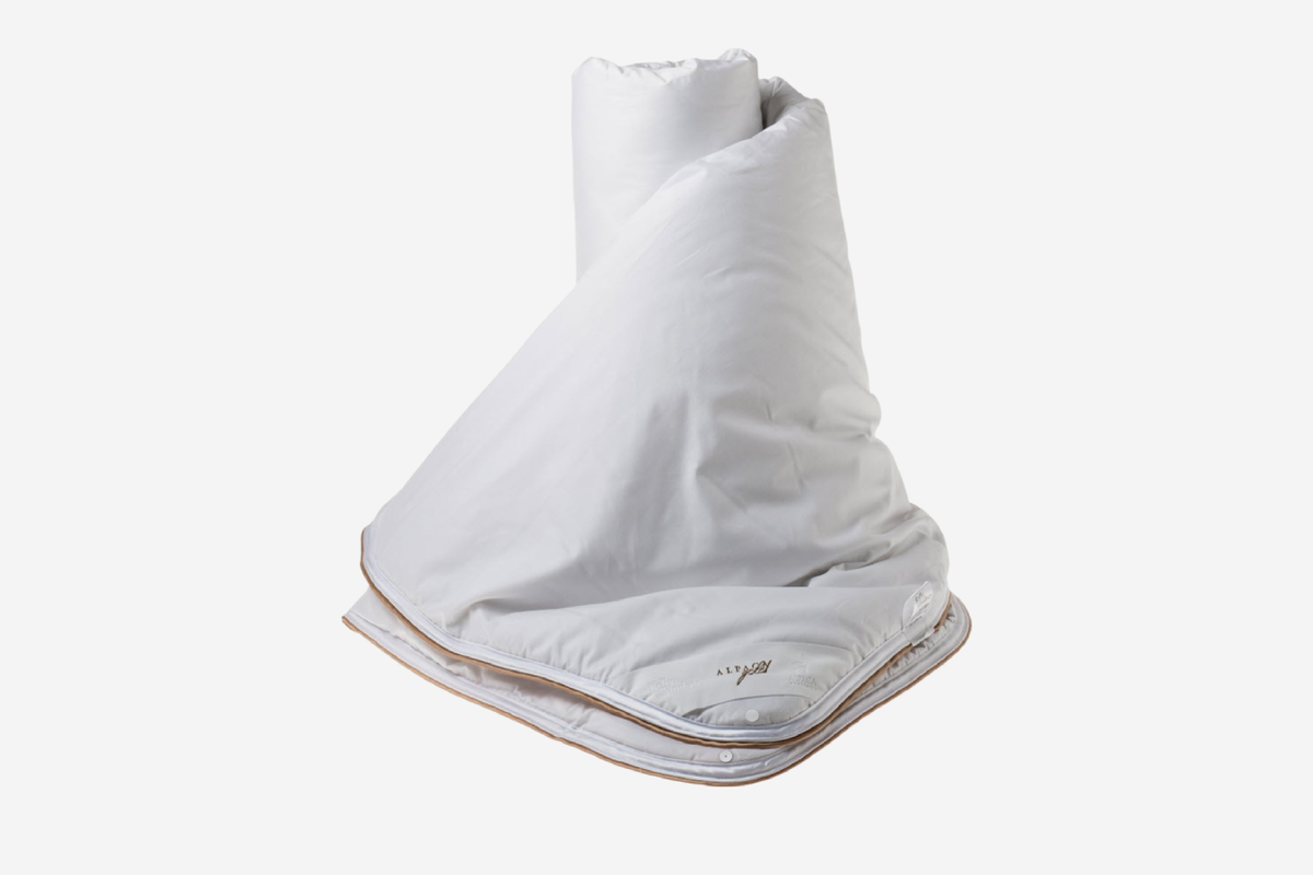 White blanket with brown trim on a white background