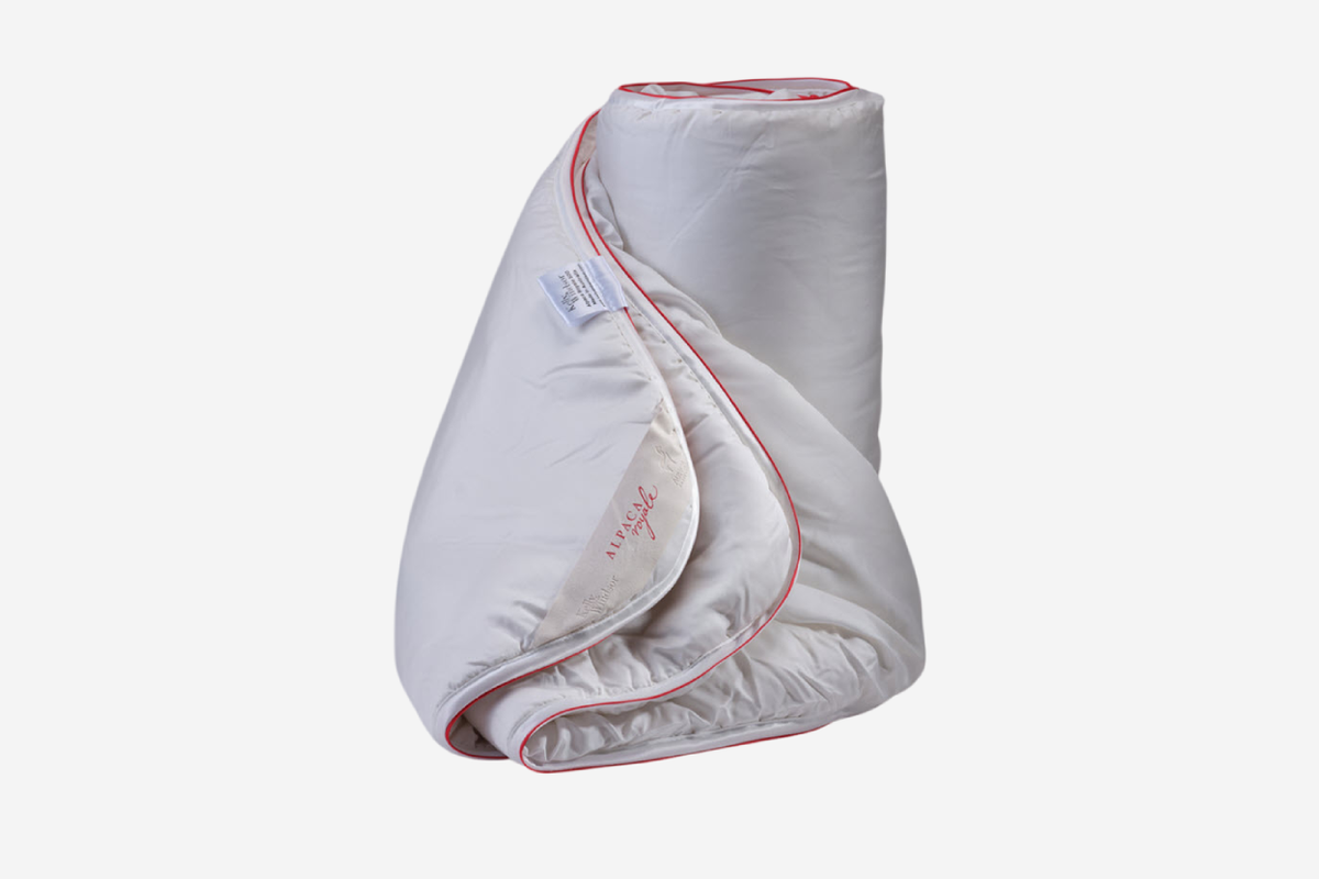 White blanket with red trim on a white background