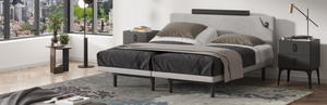 Modern bedroom setup with a bed, nightstands, and decor in a well-lit room.
