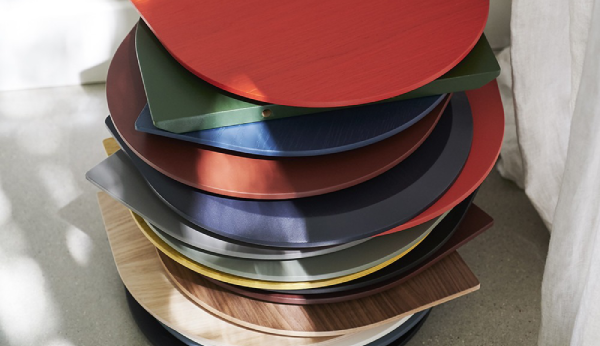 Stack of colorful round trays on a light surface