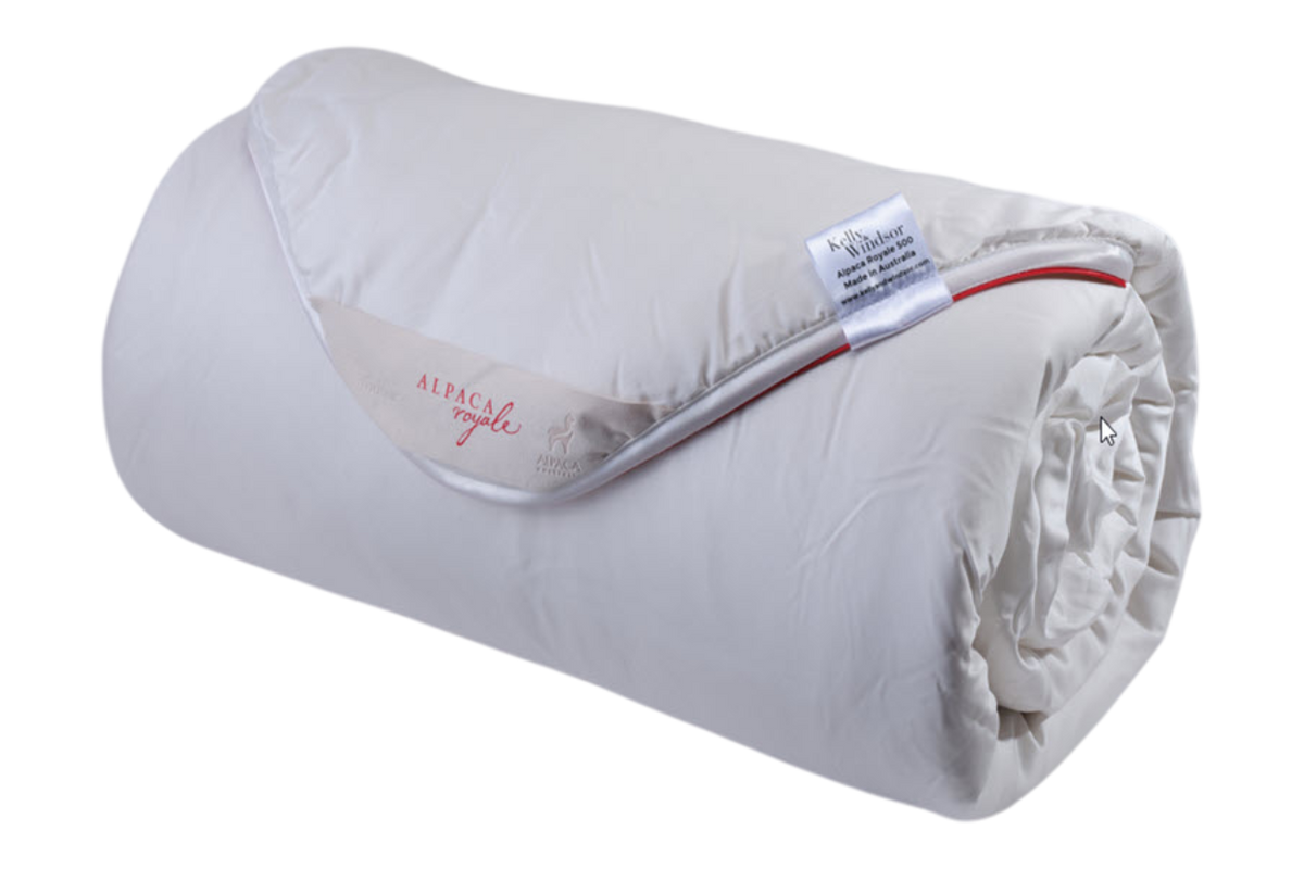 Rolled-up white blanket with a label on a white background
