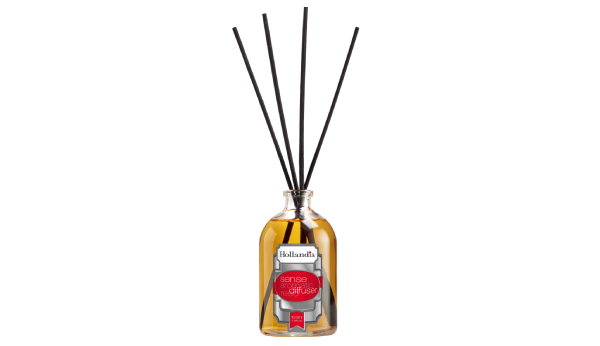 Reed diffuser with black sticks in a glass bottle on a white background
