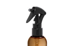 Brown spray bottle with black nozzle on a white background