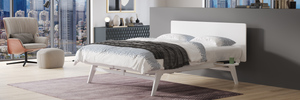 Modern bedroom with a cityscape view, bed, chair, and artwork.