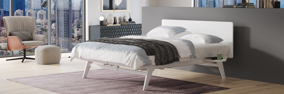 Modern bedroom with a bed, chair, and cityscape view