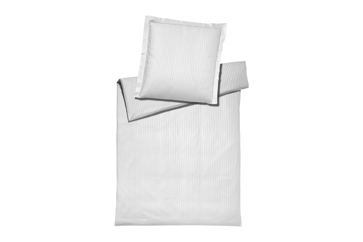 White ribbed bedding cover set and pillowcase set on a white background