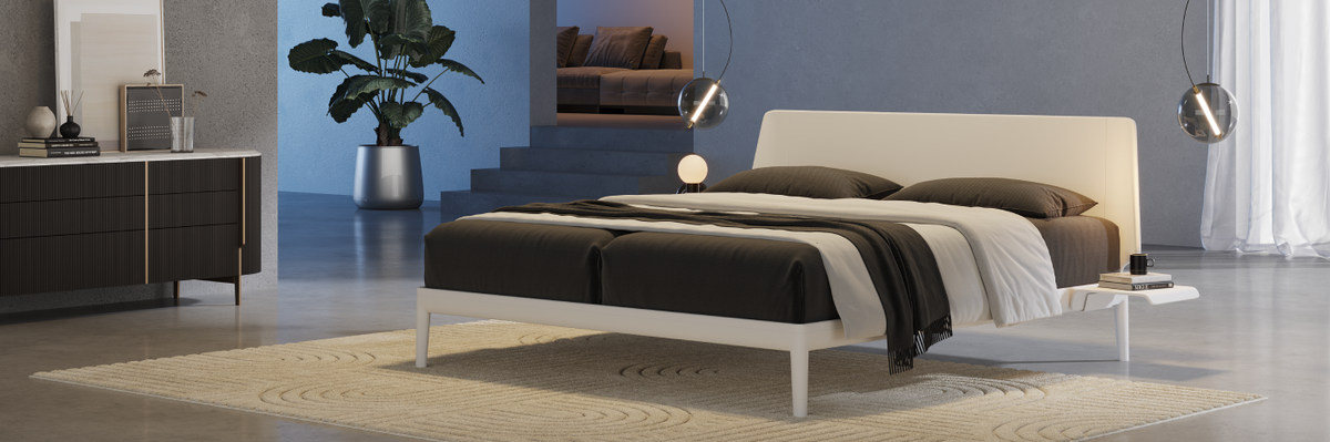 Modern bedroom with an Auping Essential bed, side tables, and decorative elements.