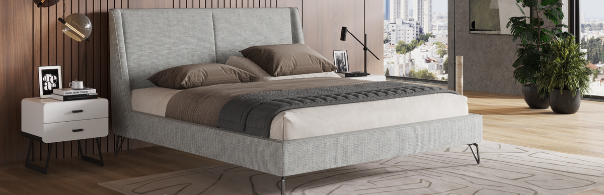 Modern bedroom with a gray PONZA bed, nightstands, and city view.