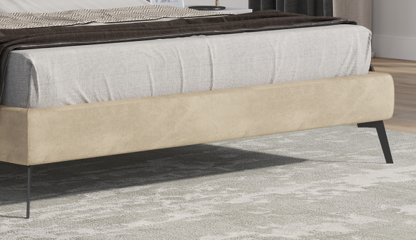 Beige bed frame with mattress on a carpeted floor