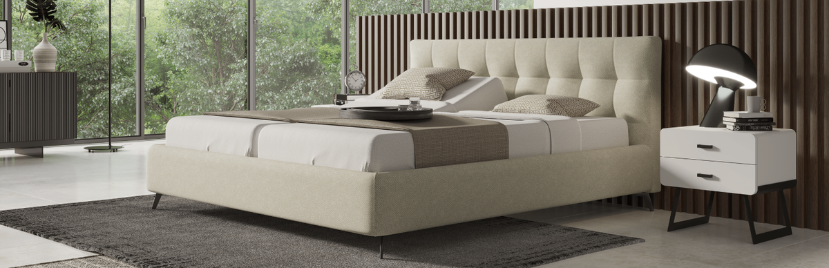 Modern bedroom with a large bed and nightstand.