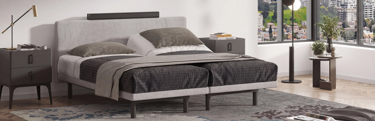 Modern bedroom setup with a bed, nightstands, and decor in a well-lit room.