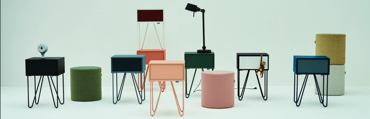 Collection of colorful stools and small tables on a light blue background