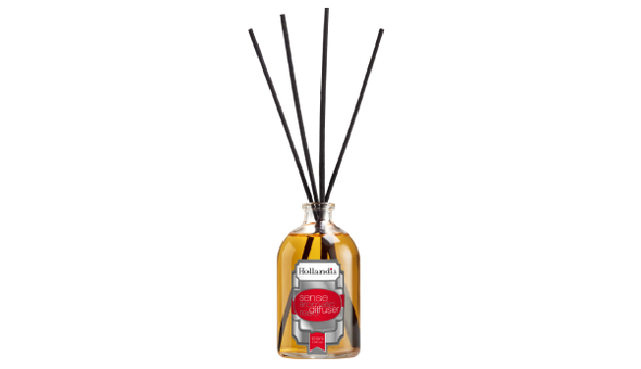 Reed diffuser with black sticks in a glass bottle on a white background