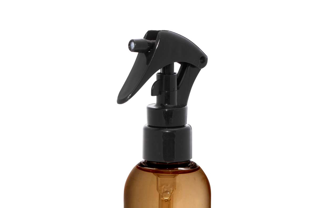 Brown spray bottle with black nozzle on a white background